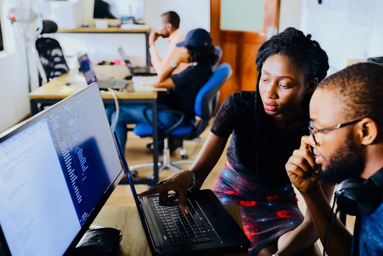 An image of two nonprofit employees working together at a computer