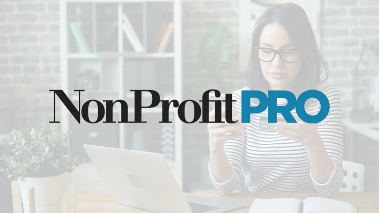 Nonprofit Pro logo in front of a faded image of a woman donating on her cell pohone