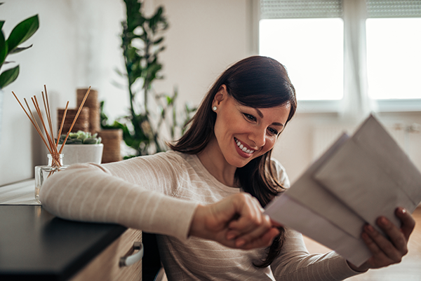 Happy woman looking through her mail