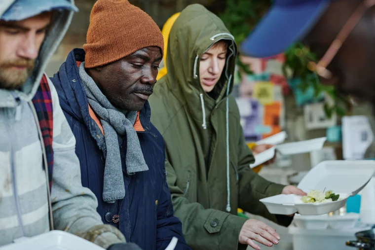 People in line at an outdoor soup kitchen