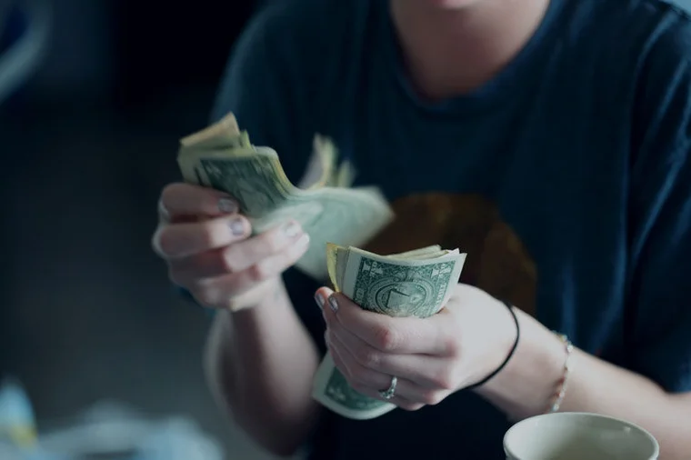 Close up of hands counting money