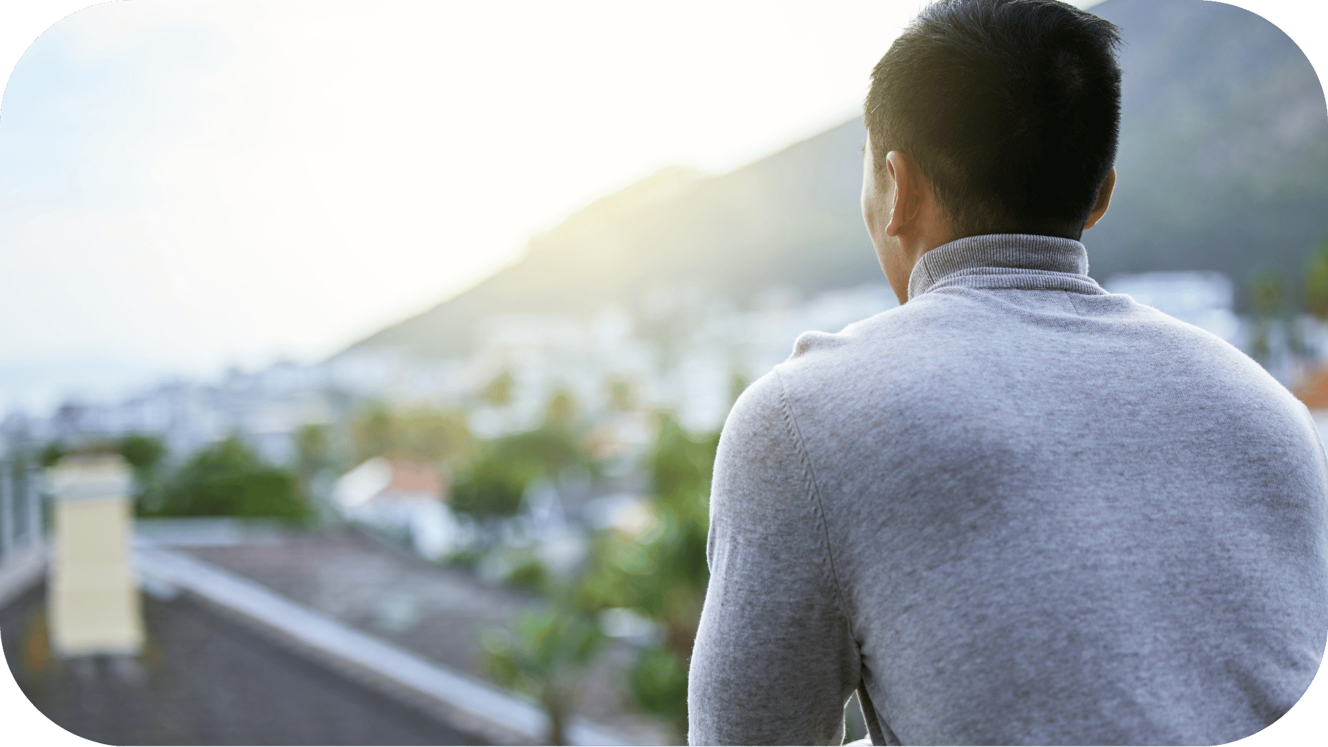 A man looking at his city from a viewpoint